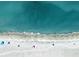Breathtaking aerial view of the beach with crystal-clear turquoise water and soft, sandy shore at 460 Daylily Blvd, Nokomis, FL 34275