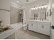 Bathroom featuring double sinks, a shower, and tile flooring at 460 Daylily Blvd, Nokomis, FL 34275