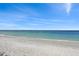 Serene beach view with gentle waves, soft sand, and a clear blue sky perfect for relaxation at 460 Daylily Blvd, Nokomis, FL 34275