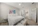 Bright bedroom with stylish art, king bed, ensuite bathroom, and an eye-catching accent wall at 460 Daylily Blvd, Nokomis, FL 34275