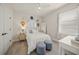 Cozy bedroom with a queen bed, two cute foot stools, decorative hats and a stylish desk at 460 Daylily Blvd, Nokomis, FL 34275