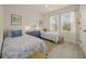 Bedroom featuring 2 beds, natural light, and neutral paint at 460 Daylily Blvd, Nokomis, FL 34275