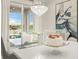 Bright dining area adjacent to the kitchen, featuring a modern chandelier, a glass-top table, and views of the water at 460 Daylily Blvd, Nokomis, FL 34275