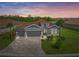Charming single-story home with tile roof, manicured lawn, and brick paver driveway at 460 Daylily Blvd, Nokomis, FL 34275