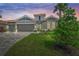 Charming single-Gathering home with a tile roof, manicured lawn, paver driveway, and neutral color scheme at 460 Daylily Blvd, Nokomis, FL 34275