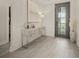 Elegant foyer featuring neutral walls, tile flooring, an entry door with a glass panel, and decorative furniture at 460 Daylily Blvd, Nokomis, FL 34275