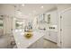 Bright kitchen features a large island, stainless steel hood, modern cabinets, and decorative lighting at 460 Daylily Blvd, Nokomis, FL 34275