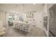 Modern kitchen with white cabinetry, stainless steel appliances, an island with bar seating, and pendant lighting at 460 Daylily Blvd, Nokomis, FL 34275