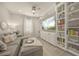 Cozy living room with built-in shelves, plush seating, and neutral décor at 460 Daylily Blvd, Nokomis, FL 34275