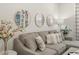 Comfortable gray sectional adorned with decorative pillows and three decorative wall mirrors at 460 Daylily Blvd, Nokomis, FL 34275