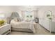 Spacious bedroom featuring a chandelier, large windows, dresser, and comfortable seating at 460 Daylily Blvd, Nokomis, FL 34275