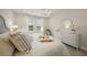 Charming main bedroom boasts serene lake views, chandelier, and a dresser with a mirror at 460 Daylily Blvd, Nokomis, FL 34275