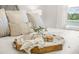 Close up of the main bedroom showing a tray on the bed with decorative pillows and mugs at 460 Daylily Blvd, Nokomis, FL 34275