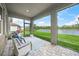 Relaxing screened lanai showing comfortable seating and a serene lake view at 460 Daylily Blvd, Nokomis, FL 34275