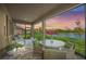 Screened lanai features seating area with view of the backyard and scenic lake at 460 Daylily Blvd, Nokomis, FL 34275