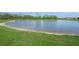 Scenic view of the community pond showing the manicured lawn down to the water's edge at 460 Daylily Blvd, Nokomis, FL 34275