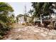 Charming backyard featuring a tranquil garden, lush tropical foliage, and stone walkway at 4945 Camphor Ave, Sarasota, FL 34231