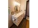 Bright bathroom featuring a modern vanity, decorative mirror, and stylish stone backsplash at 4945 Camphor Ave, Sarasota, FL 34231
