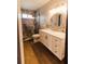 Bathroom showcasing a stylish vanity, mosaic backsplash, and glass-enclosed shower at 4945 Camphor Ave, Sarasota, FL 34231