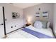 Well-lit bedroom featuring a cozy bed with stylish bedding and wall decor at 4945 Camphor Ave, Sarasota, FL 34231