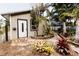 Charming exterior featuring a unique backyard with tropical foliage and stone walkway at 4945 Camphor Ave, Sarasota, FL 34231