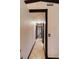 Interior hallway with tile flooring, trim, and doors leading to various rooms at 4945 Camphor Ave, Sarasota, FL 34231