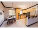 Modern kitchen with wood cabinetry, stainless steel appliances, and an adjacent dining area at 4945 Camphor Ave, Sarasota, FL 34231