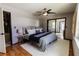 Main bedroom with a comfortable bed, ceiling fan, and access to additional living space at 4945 Camphor Ave, Sarasota, FL 34231