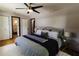Spacious main bedroom with a plush bed, ceiling fan, and stylish decor at 4945 Camphor Ave, Sarasota, FL 34231