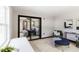 Sitting room with views to the main bedroom featuring a desk, stylish art, and comfy seating at 4945 Camphor Ave, Sarasota, FL 34231
