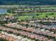 Detailed aerial view of a residential neighborhood featuring a lush golf course and serene lakes at 4949 Savona Run, Bradenton, FL 34211