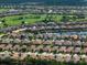 Panoramic aerial view of a community showcasing beautiful homes near a golf course and tranquil lakes at 4949 Savona Run, Bradenton, FL 34211