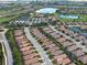 High angle of an entire residential community featuring a golf course, lakes, and a recreational facilities at 4949 Savona Run, Bradenton, FL 34211