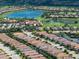 Stunning aerial view of a home in a golf community with lake views and lush landscaping at 4949 Savona Run, Bradenton, FL 34211