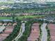 Wide aerial view of an entire neighborhood complete with a golf course, lakes, and recreational facilities at 4949 Savona Run, Bradenton, FL 34211