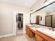 Spacious bathroom featuring double vanities, walk-in closet, and tiled floors at 4949 Savona Run, Bradenton, FL 34211