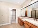 Bathroom featuring double vanities, walk-in closet, and tiled floors at 4949 Savona Run, Bradenton, FL 34211