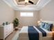 Cozy bedroom featuring stylish lamps, shutters, and a decorative ceiling fan at 4949 Savona Run, Bradenton, FL 34211