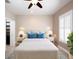 Comfortable bedroom featuring stylish lamps, shutters, and ceiling fan at 4949 Savona Run, Bradenton, FL 34211