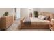 Bright and airy bedroom with stylish wooden bed frame, dresser, and neutral decor at 4949 Savona Run, Bradenton, FL 34211