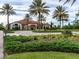 Beautiful Esplanade clubhouse surrounded by manicured landscaping and stately palm trees at 4949 Savona Run, Bradenton, FL 34211