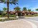 Inviting clubhouse entrance with well-manicured landscaping and distinctive architecture in a tropical setting at 4949 Savona Run, Bradenton, FL 34211