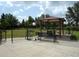 Community dog park with a covered shelter, benches, and ample space for furry friends to play and socialize at 4949 Savona Run, Bradenton, FL 34211