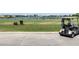 A golf cart is parked near the driving range for golfers to practice their swing in the community at 4949 Savona Run, Bradenton, FL 34211