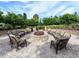 Cozy outdoor fire pit with cushioned seating, perfect for relaxing and entertaining in a landscaped setting at 4949 Savona Run, Bradenton, FL 34211