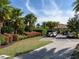 View of golf carts parked along paved path surrounded by mature landscaping and palm trees at 4949 Savona Run, Bradenton, FL 34211