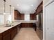 Well-lit kitchen featuring stainless steel appliances, tile backsplash, and dark wood cabinetry at 4949 Savona Run, Bradenton, FL 34211