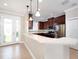 Stylish kitchen featuring dark wood cabinets, stainless steel appliances, and a breakfast bar at 4949 Savona Run, Bradenton, FL 34211