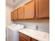 Well-equipped laundry room with modern washer and dryer, ample storage cabinets, and convenient utility sink at 4949 Savona Run, Bradenton, FL 34211
