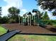 Community playground with climbing structures, a slide, and a soft landing surface for safe and active play at 4949 Savona Run, Bradenton, FL 34211
